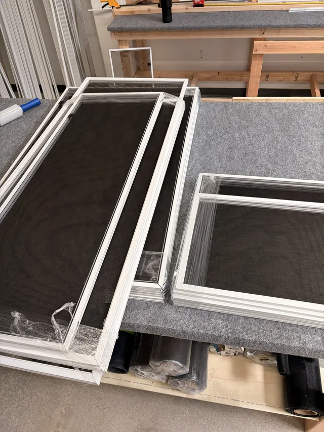 Window screens on the workbench at 24 Hour Screens